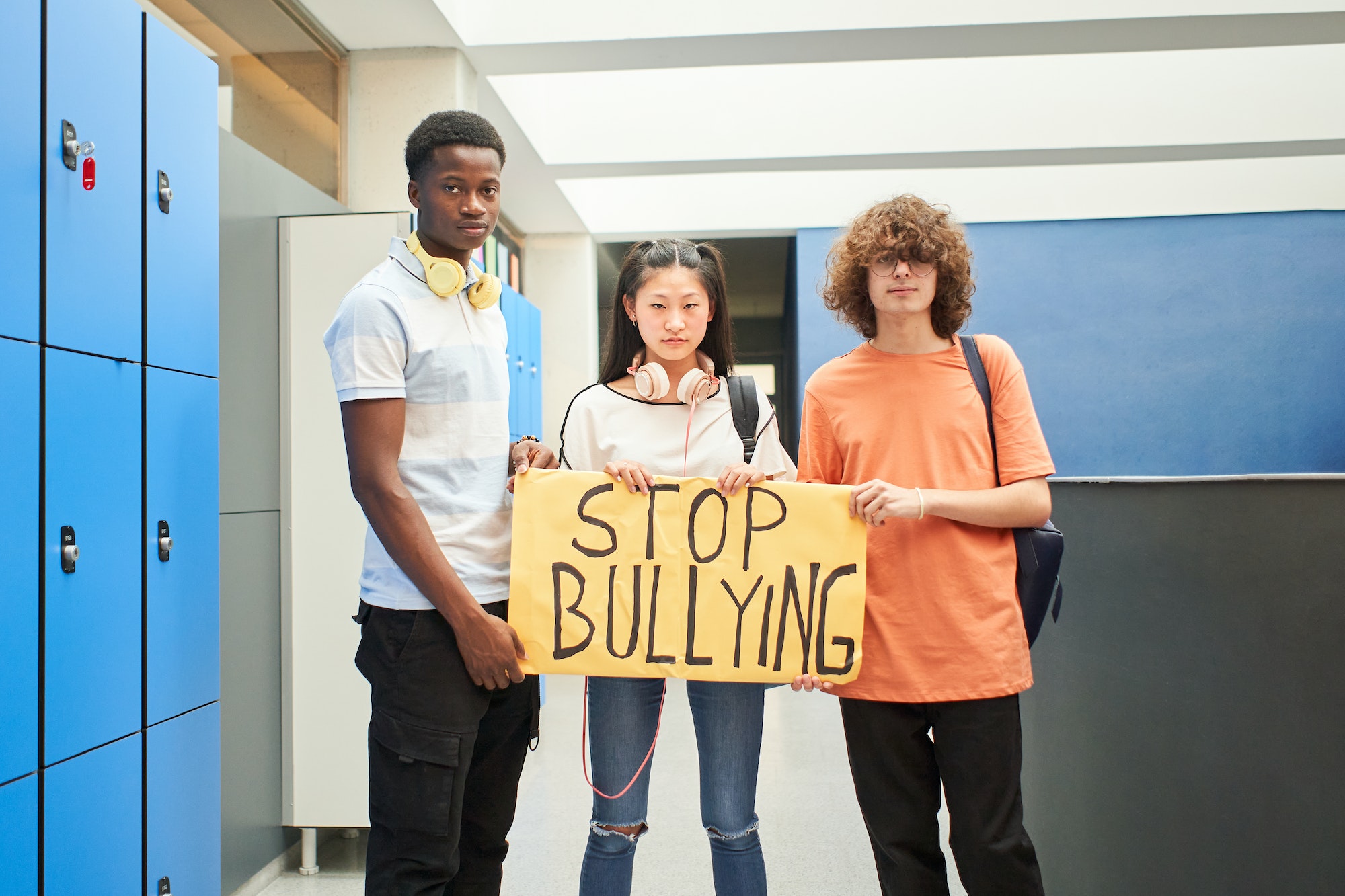 A group of students display a banner with the phrase: Stop Bullying.